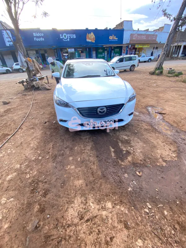 White Mazda Atenza saloon car
