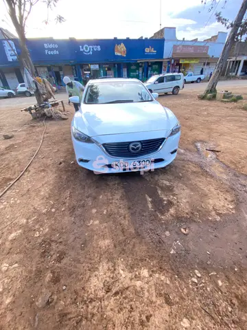 White Mazda Atenza saloon car