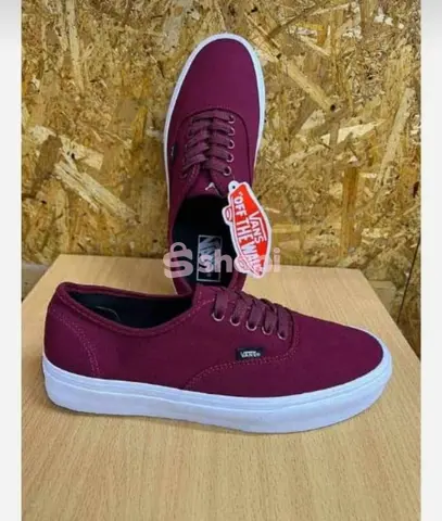 Maroon Vans off the wall