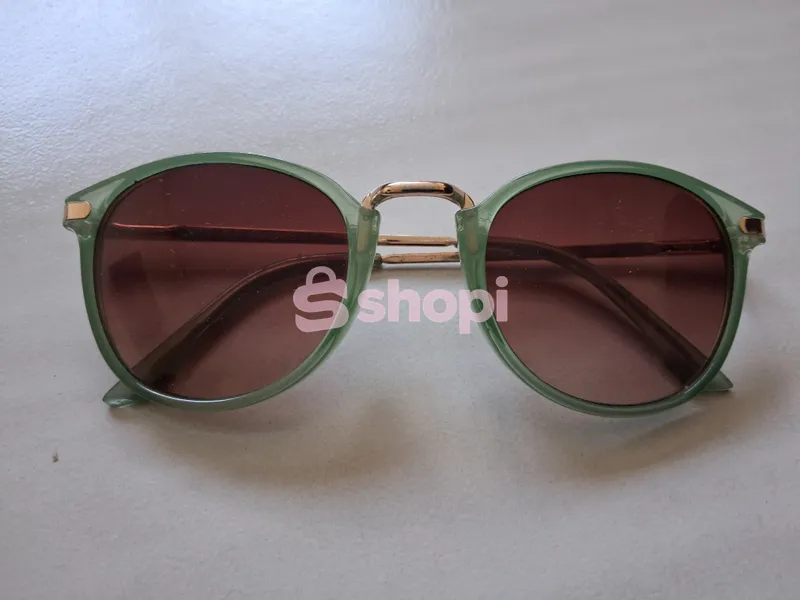 Green frame round sunglasses with tinted lenses